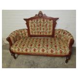 Victorian parlor settee. floral upholstery.