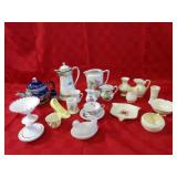 Belleek pitchers, vase, assorted teapots, milk gla