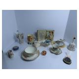 Tea cups & saucers, figures, glass paperweight.