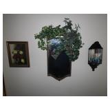Floral painting, wall mirror, candle sconce.