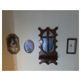 Mirrored shelf, framed prints.