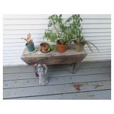Wood bench, plants, Angel figure.