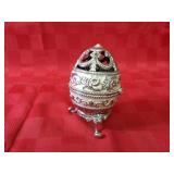 Jeweled egg figure w/cross inside.