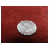 1964- 90% silver US coin. Kennedy half.