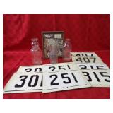 Post magazine, milk bottles, number signs.