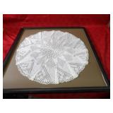 Framed doily wall decor.