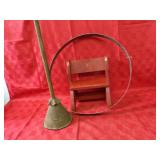 Metal ring, washer plunger, wood stool.