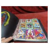 Binder of assorted Marvel trading cards.