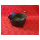 Footed cast iron pot w/bail handle.