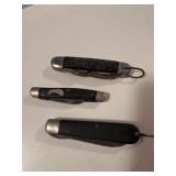 Three old pocket knives. The small one is