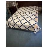 Handmade quilt shown on a full size bed