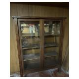 Antique wood display cabinet with glass doors.