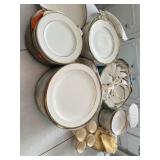 Gold and white China. Tea cups, and saucers, are