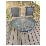 Two outdoor chairs, and one round metal side