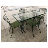 Glass topped metal table and four chairs. Paint