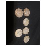 Six Kennedy half dollars. Two 1964, one 1965, two
