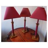 Three matching red lamps red base and red shade