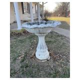 Concrete birdbath. Bowl has chips and cracks.