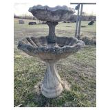 Concrete birdbath. Has some chips and cracks.