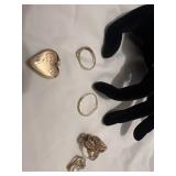 7 ladies rings, one heart shaped locket and one