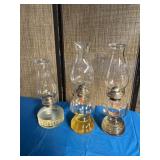 Three kerosene lamps. The kerosene in that middle