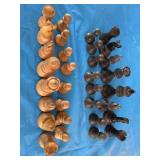 Antique/vintage wooden chess pieces in a wooden