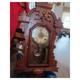 Vintage clock has its key and pendulum this c