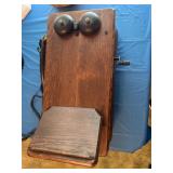 Antique wall mounted wood telephone. Has a