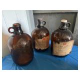 3 brown glass gallon jugs