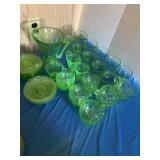 Vaseline glass pitcher, glasses and saucers