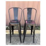 Pair of black with red accent metal barstools.