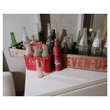 Old glass bottles mostly soda bottles two wood