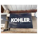 Kohler metal sign and clock. Measures 23 x 34.
