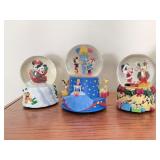 Three musical Disney snow globes
