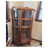 Curved glass China cabinet. Appears the back has