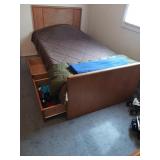 Twin size bed with two drawers and a cubby hole