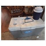 Coleman cooler, Rubbermaid water jug, broom