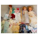 Assorted dolls and doll clothes