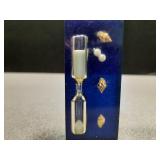 Resin encased hourglass with seashells