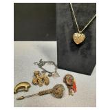 Assorted jewelry. Heart pendant, charm bracelet,