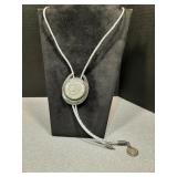 Silver bolo tie with silver dollar center piece