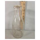 One quart embossed milk bottle