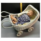 Antique doll, blanket & wicker buggy