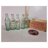 Coke, crate, sun catcher, husker bottles