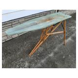 Vintage wooden ironing board with green painted