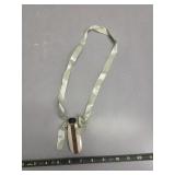 Bone and copper perfume bottle on ribbon