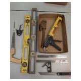 Caulk gun, levels, saw, wrench +