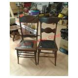 > Two vintage wood chairs with leather seats