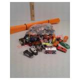 Lot of Hot Wheels cars and Hot Wheels race track