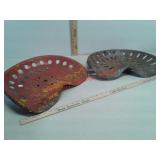 Two metal tractor seats